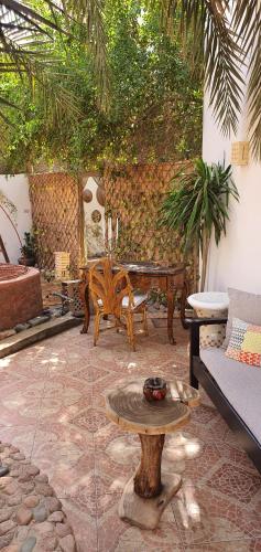 a patio with a table and a couch and a table at Villa Can Kiko in Dahab