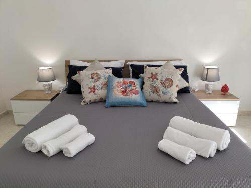 a large bed with white pillows on it at InCentro Palermo in Palermo