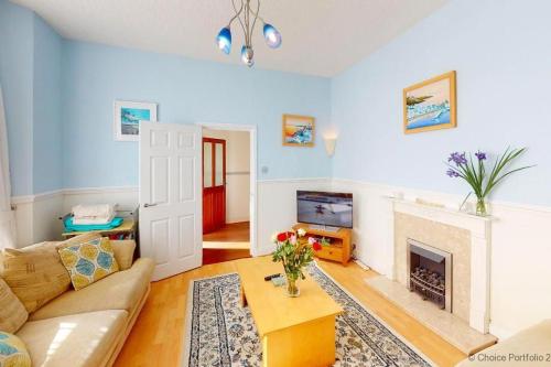 a living room with a couch and a fireplace at WOOLACOMBE HIBISCUS 2 Bedrooms in Woolacombe