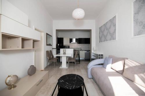 a white living room with a couch and a table at Apartment Val with sea view in Šibenik