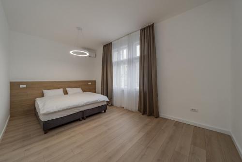 a bedroom with a bed and a large window at BG Exclusive Suites in Belgrade