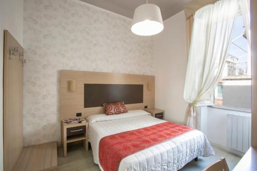 a bedroom with a bed and a large window at Hotel Playa in Viareggio
