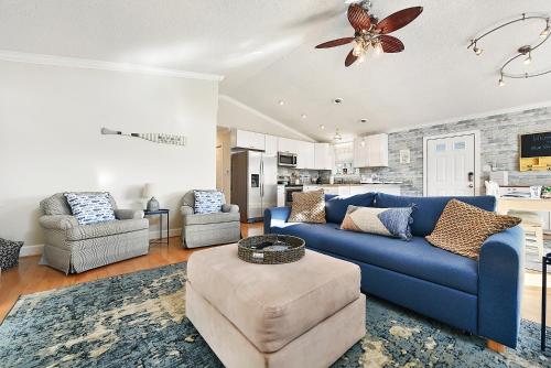 a living room with a blue couch and two chairs at Walk to the Beach at the Blue House! EV Cgr, Pets! in Ocean City