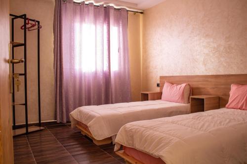 Uma cama ou camas num quarto em Dakhla Cabana Hotel Apartment