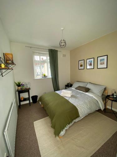 a bedroom with a large bed and a window at Cheerful and Cosy Double Room in Belfast
