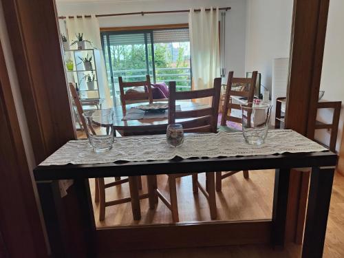a dining room table and chairs with glasses on it at Cosy sunny flat between center and beach in Porto