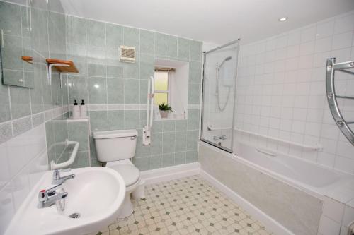 a bathroom with a toilet and a sink and a shower at Shepherds Cottage - Rudge Farm Cottages in Bridport