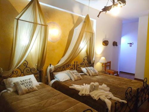 a bedroom with two beds with costumes on them at Athina-Milina in Milína