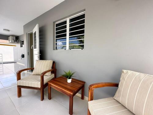 a living room with a couch and a table at Lirmar Apartments in Kralendijk