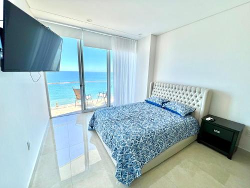 a bedroom with a bed with a view of the ocean at Camino al Mar 802 Vista al Mar in Mazatlán