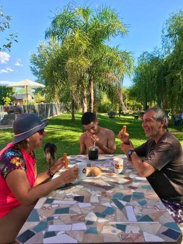 a group of people sitting at a table eating food at Bendito Alcázar Cabañas in Colón