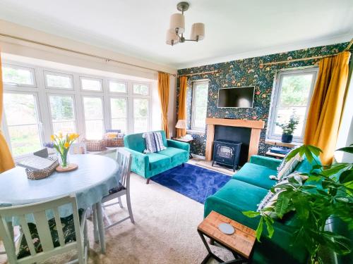 a living room with a couch and a table at Burnside Cottage in Sleights