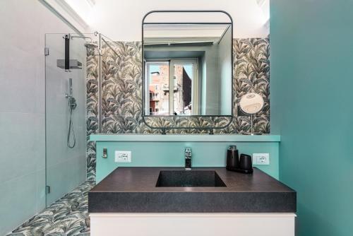 a bathroom with a sink and a mirror at Residenze Florio in Catania