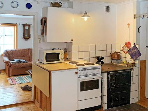 a kitchen with a microwave and a stove top oven at 6 person holiday home in TÖCKSFORS-By Traum in Töcksfors