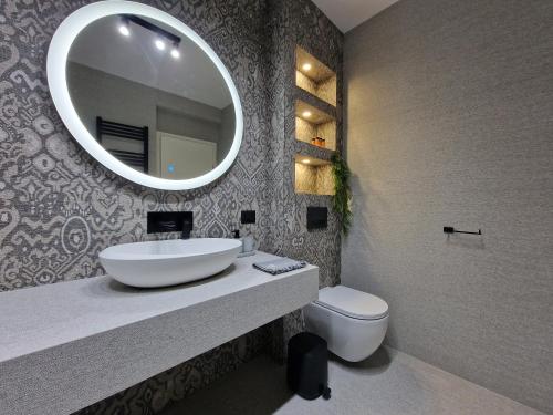 a bathroom with a sink and a toilet and a mirror at SeaHouse by Jelena in Bibinje
