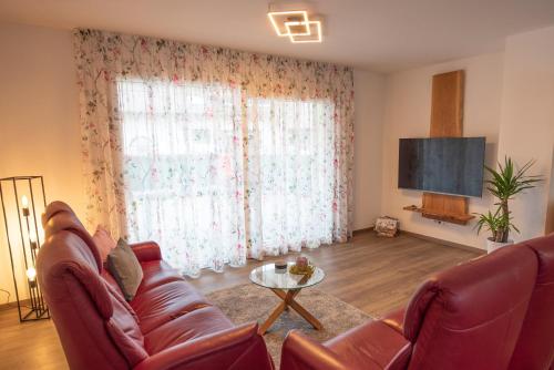 a living room with a couch and a tv at Bergstern in Freudenstadt