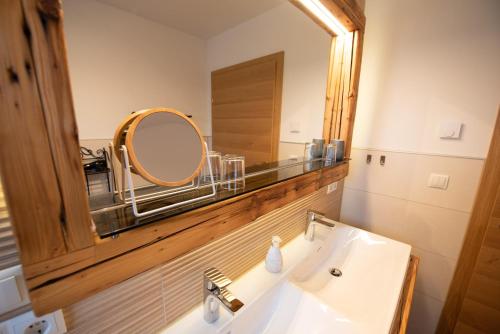 a bathroom with a sink and a large mirror at Bergstern in Freudenstadt