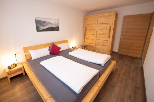 a bedroom with two beds and a closet at Bergstern in Freudenstadt