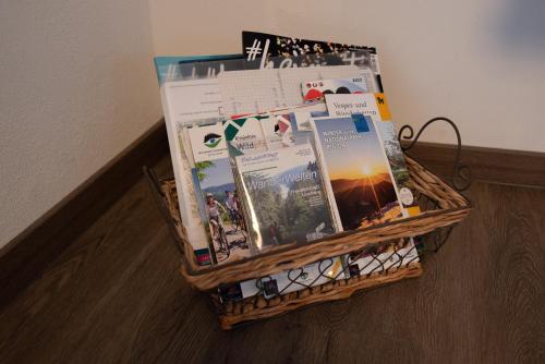 a basket full of magazines sitting on the floor at Bergstern in Freudenstadt
