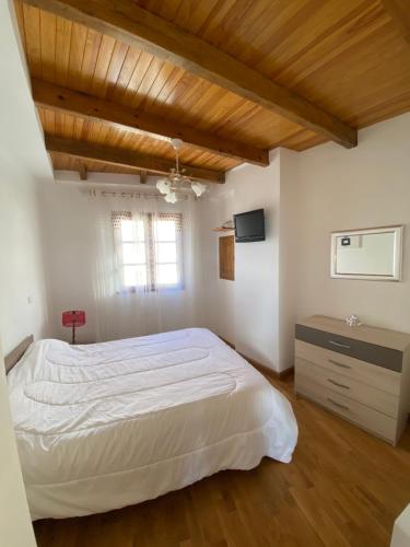 ein Schlafzimmer mit einem weißen Bett und einer Holzdecke in der Unterkunft Maison de village VUE 360° in Farinole