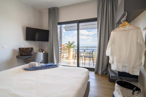 a hotel room with a bed and a balcony at Taormina Palace Hotel in Taormina