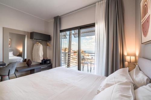 a hotel room with a bed and a balcony at Taormina Palace Hotel in Taormina