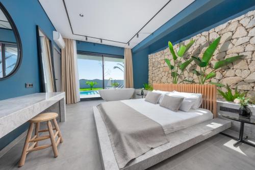 a bedroom with a large bed and a bath tub at Villa Milo in Side