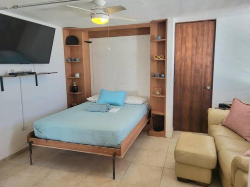 a bedroom with a bed and a couch at Steps to the Beach l Private Apt Stay l Parking WiFi Nightlife in San Juan