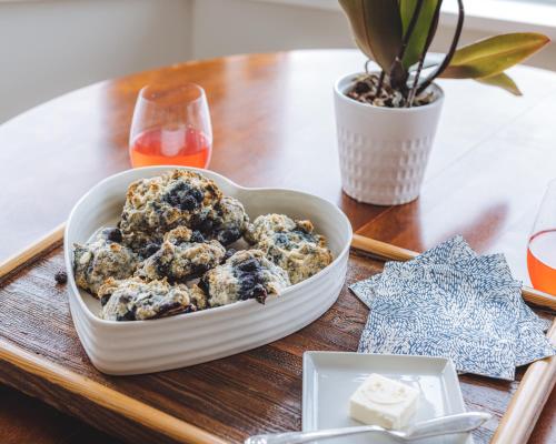 a bowl of blueberry muffins on a table at By the Bay Lavender Villa in Chemainus