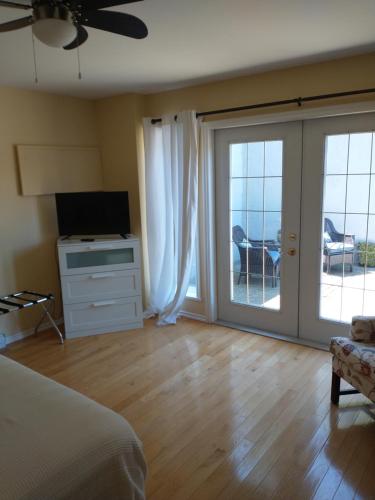 a bedroom with a bed and a sliding glass door at By the Bay Lavender Villa in Chemainus