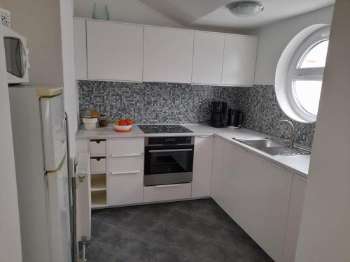 Η κουζίνα ή μικρή κουζίνα στο Apartments A&T