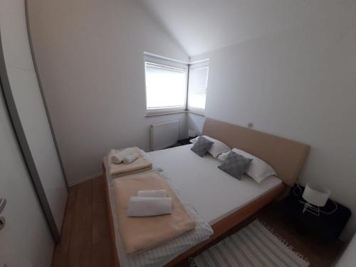Ένα ή περισσότερα κρεβάτια σε δωμάτιο στο Apartments A&T