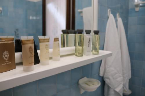 a shelf in a bathroom with some products on it at Beach House Riviera in Lignano Sabbiadoro