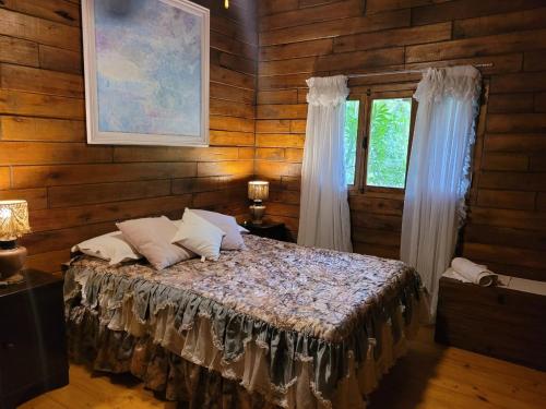 a bedroom with a bed in a wooden room at RUNA Yaku in Salta