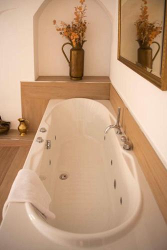 a white bath tub in a bathroom with a mirror at Castillo de Bulbuente de Luis Zueco in Bulbuente