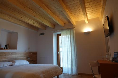 a bedroom with a large bed and a window at Casale Bella.Vista in Pianello Del Lario