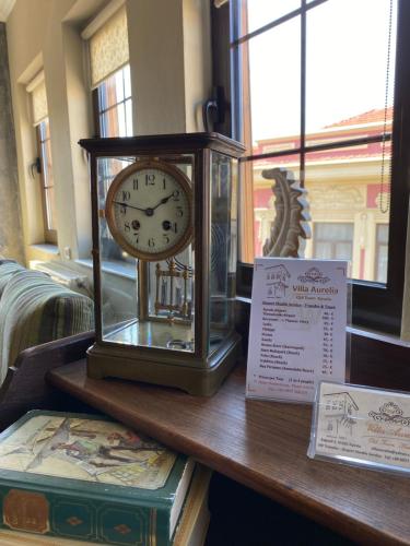 a clock sitting on top of a table at Villa Aurelia Old Town in Kavala