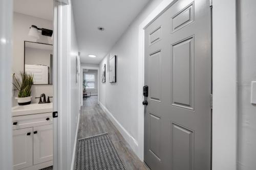 a hallway with a white door and a sink at 4BR 1BH Apt in South Boston near Old Harbor Beach in Boston