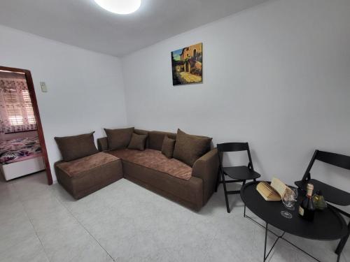 a living room with a couch and a table at Apartman Dora with sea view and terrace in Umag