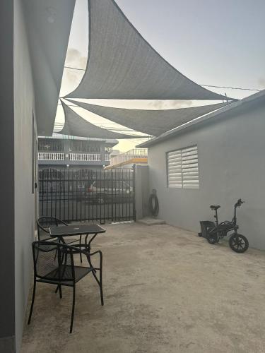 a patio with a table and a bike next to a building at Perfect suite #3 in San Juan