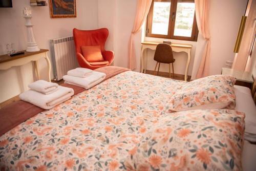 a bedroom with a bed with towels on it at Castillo de Bulbuente de Luis Zueco in Bulbuente
