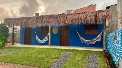 a blue building with hammocks on the side of it at Milagres Retrô- Studio in São Miguel dos Milagres