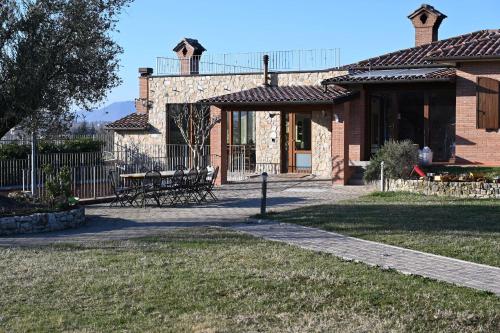 a brick house with a walkway in front of it at Agriturismo A Casa Mia Gubbio in Gubbio