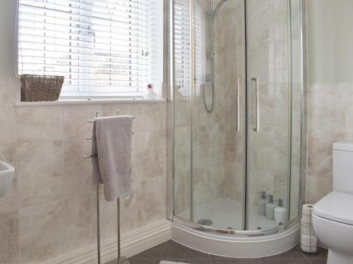 a bathroom with a shower and a toilet at The Lodge in Cosham