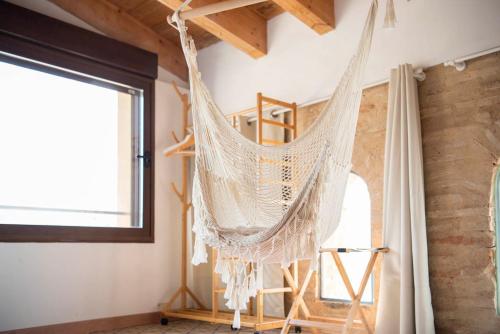 a hammock hanging from the ceiling of a room at Castillo de Bulbuente de Luis Zueco in Bulbuente