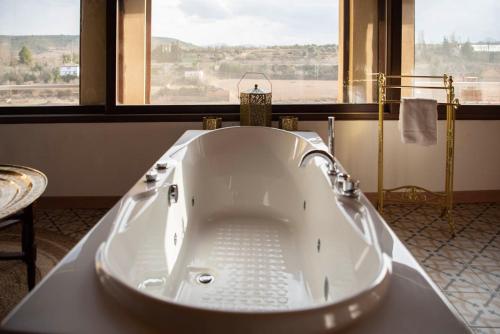 a large bath tub in a bathroom with a window at Castillo de Bulbuente de Luis Zueco in Bulbuente