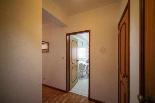 an empty hallway with a door to a room at Apartamento Edumar in Vila do Conde