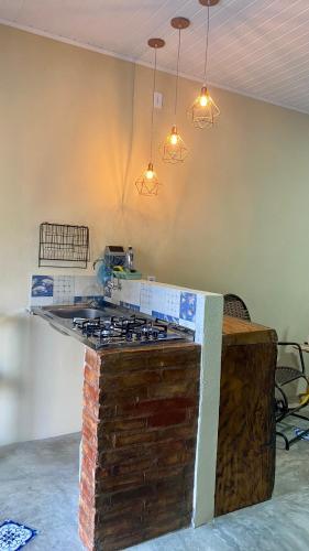 a kitchen with a stove top in a room at Milagres Retrô- Studio in São Miguel dos Milagres