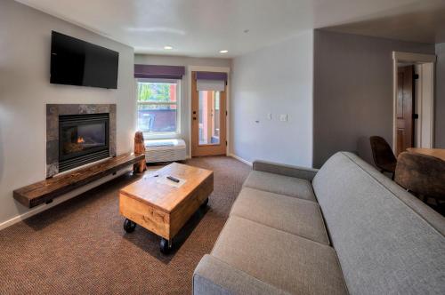a living room with a couch and a fireplace at The Gonzo Inn in Moab