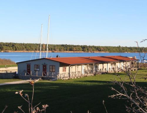 a large building with a lake in the background at Valleviken Hotell in Valleviken